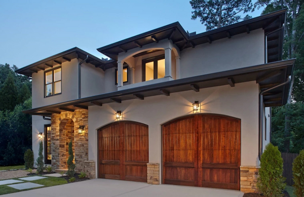 Beautiful Arched Wood Panel Garage Doors on a Mediterranean Home
