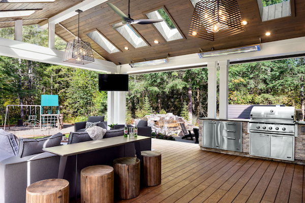 A Gorgeous Outdoor Living Space with a Wood Deck, Outdoor Kitchen, and Vaulted Ceiling