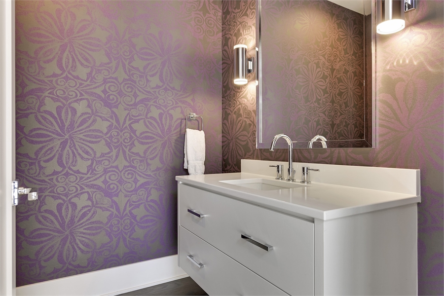 a powder room with wallpaper