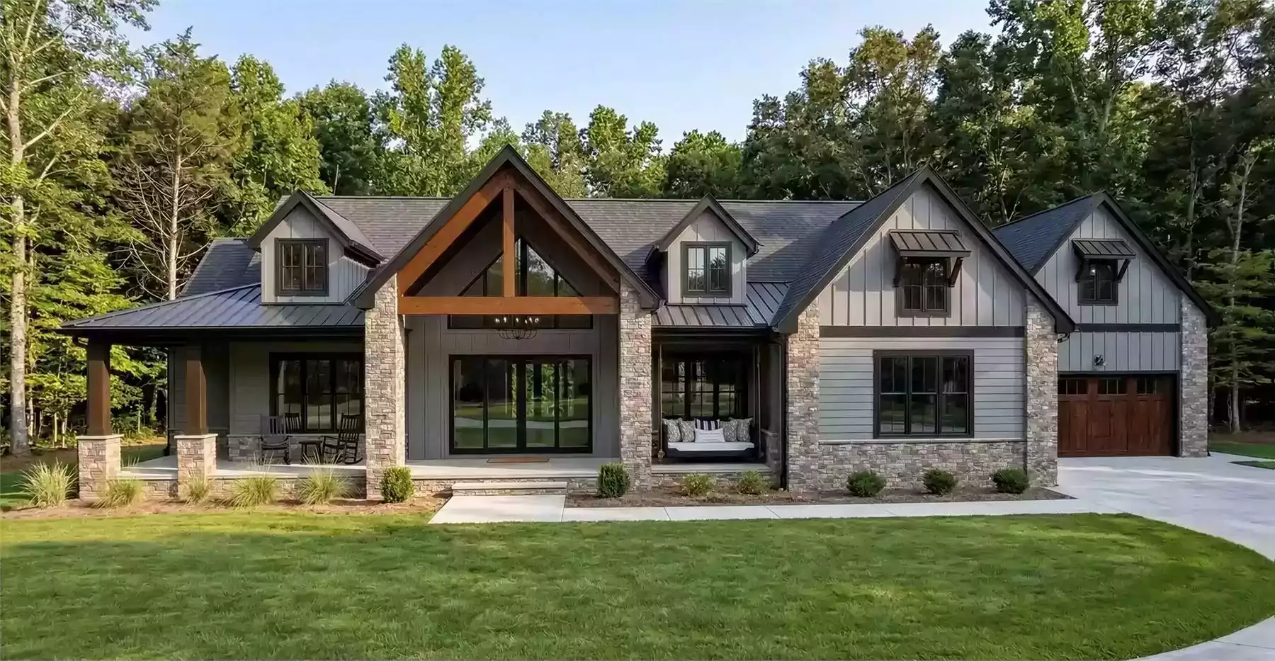 3 bedroom Craftsman style house plan with stone exterior, wood beams, covered front porch, and modern rustic design