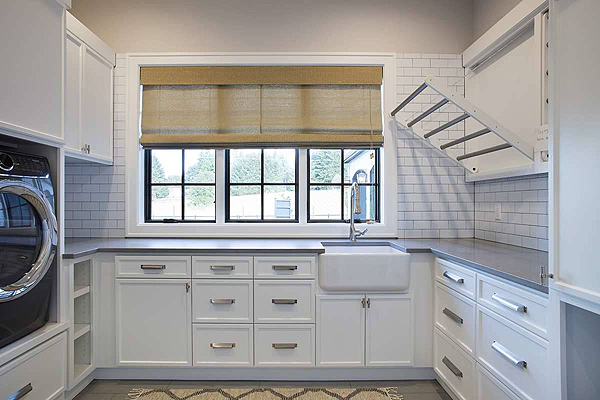 A Neat Laundry Room with Storage and a Drying Rack in a Gorgeous Luxury Home