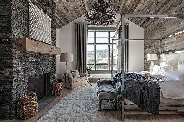 A Stunning, Nature-Inspired Bedroom with Stone Fireplace Accent and Wood Paneling