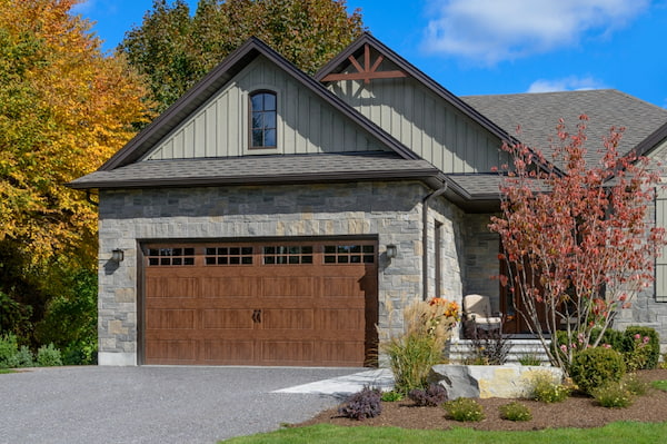 Raised Panel Garage Doors with a Wood-Look Finish on a Traditional Home