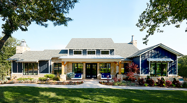 A Blue Farmhouse Ranch with Chic Wood Windows with Black Frames and Grilles