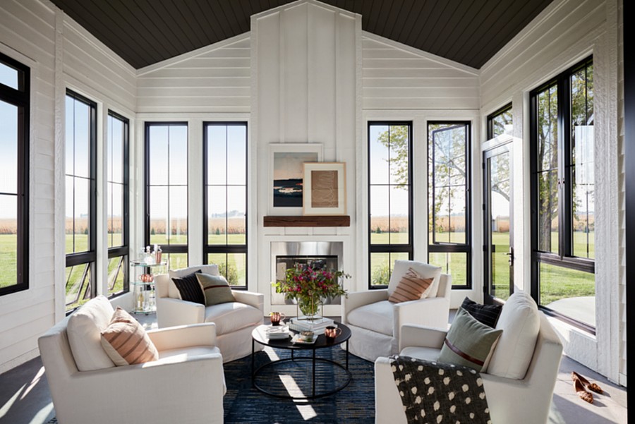 A Cozy Sunroom with a Fireplace, a Vaulted Ceiling, and Plenty of Casement and Awning Windows