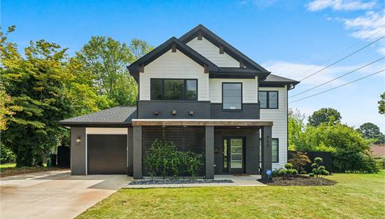 Front View featuring Clopay garage door and GAF roofing